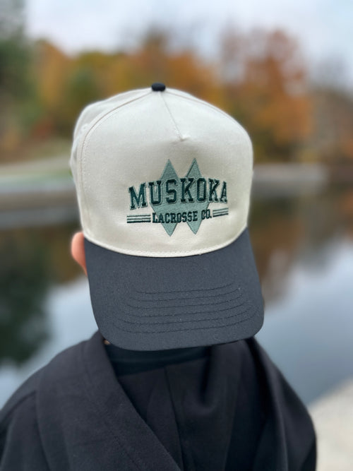 Muskoka Lacrosse Heritage Snapback with Ivory Crown, embroidered logo and black brim. 