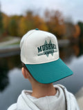 Muskoka Lacrosse Heritage Snapback with Ivory Crown, embroidered logo and green brim. 